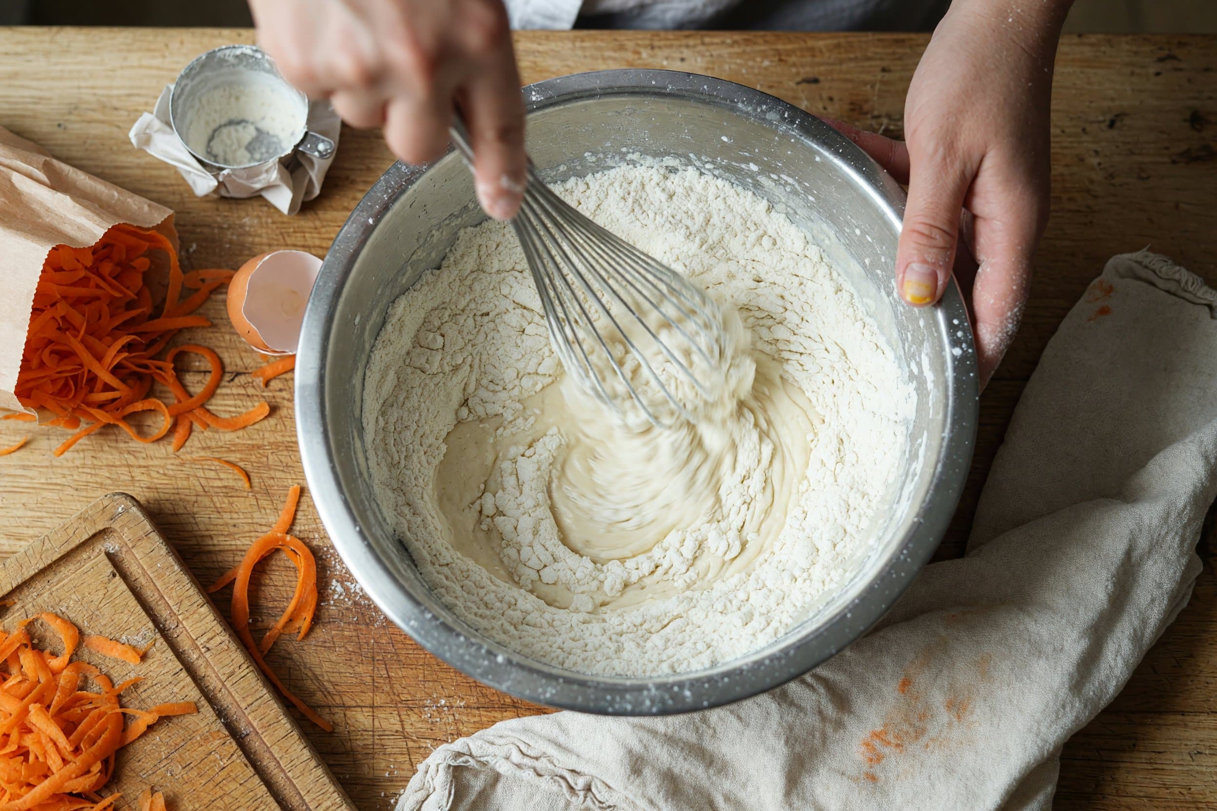 Whisking flour while preparing Simply Carrot Cake Cupcakes